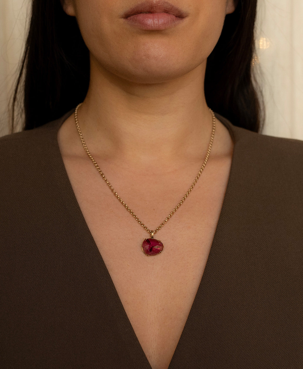 One of a Kind Charm 492 with a rose cut pink tourmaline worn by a model on a belcher chain.