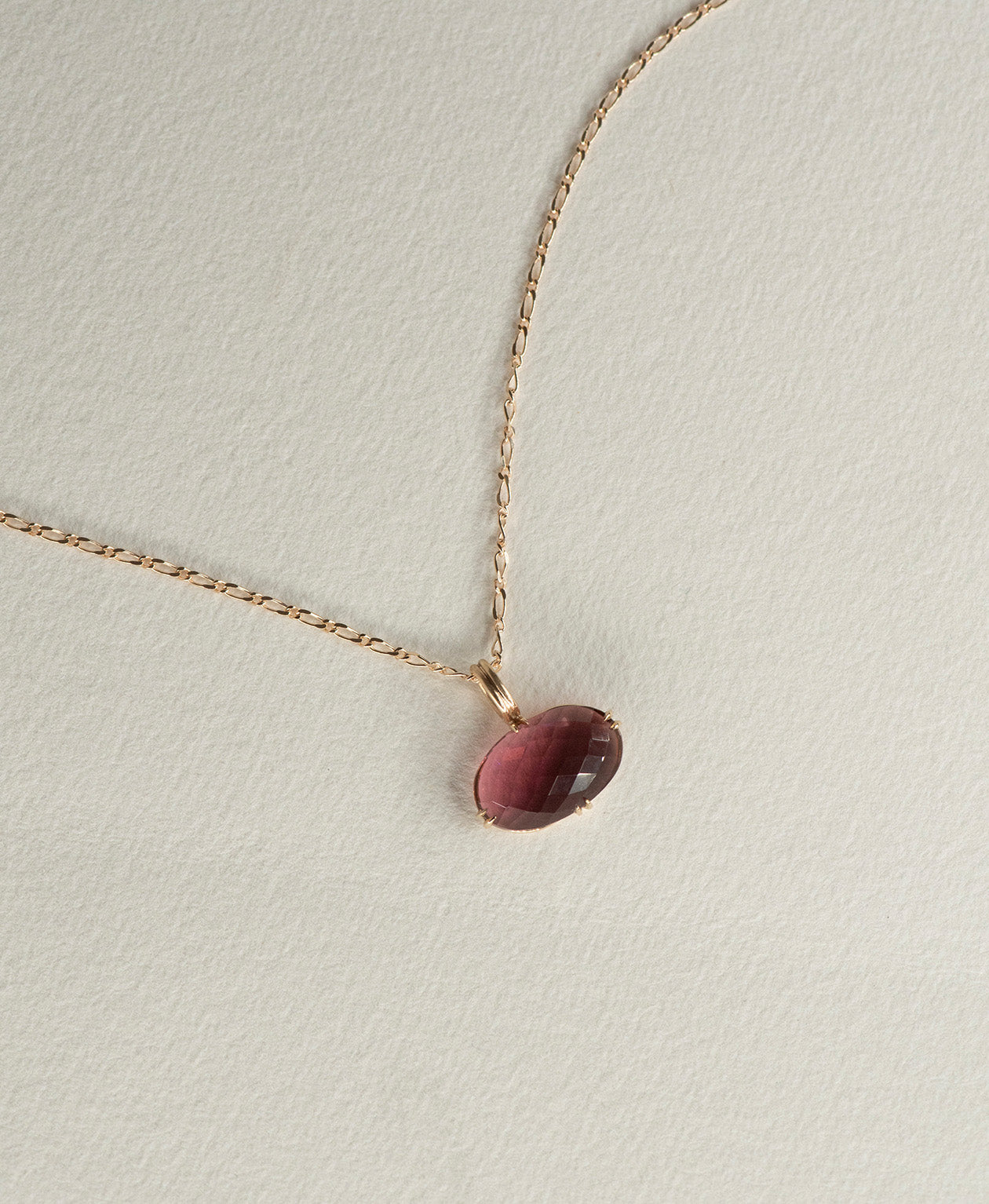 One of a Kind Charm 493 with a checkerboard cut fuchsia pink tourmaline on a figaro chain.