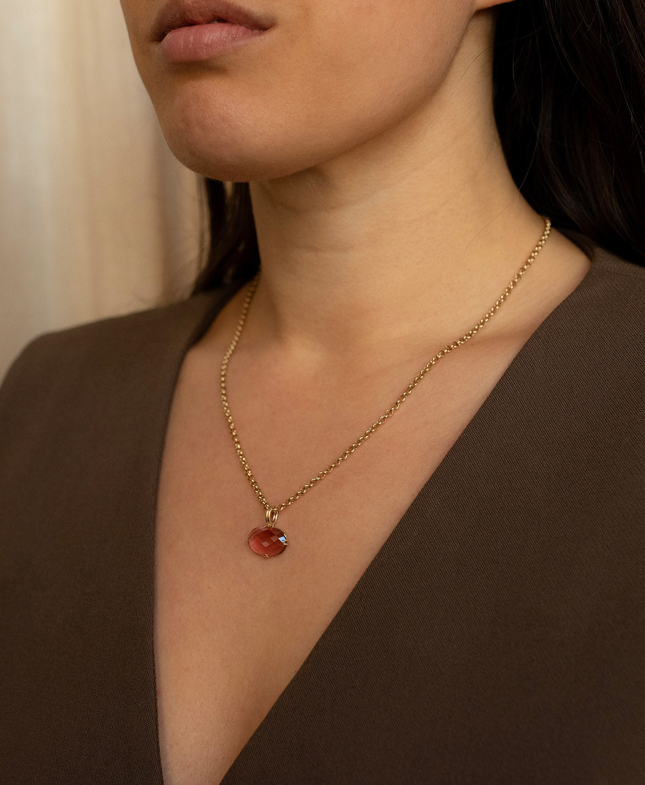 Close up of the One of a Kind Charm 493 with a checkerboard cut fuchsia pink tourmaline worn by a model on a belcher chain.