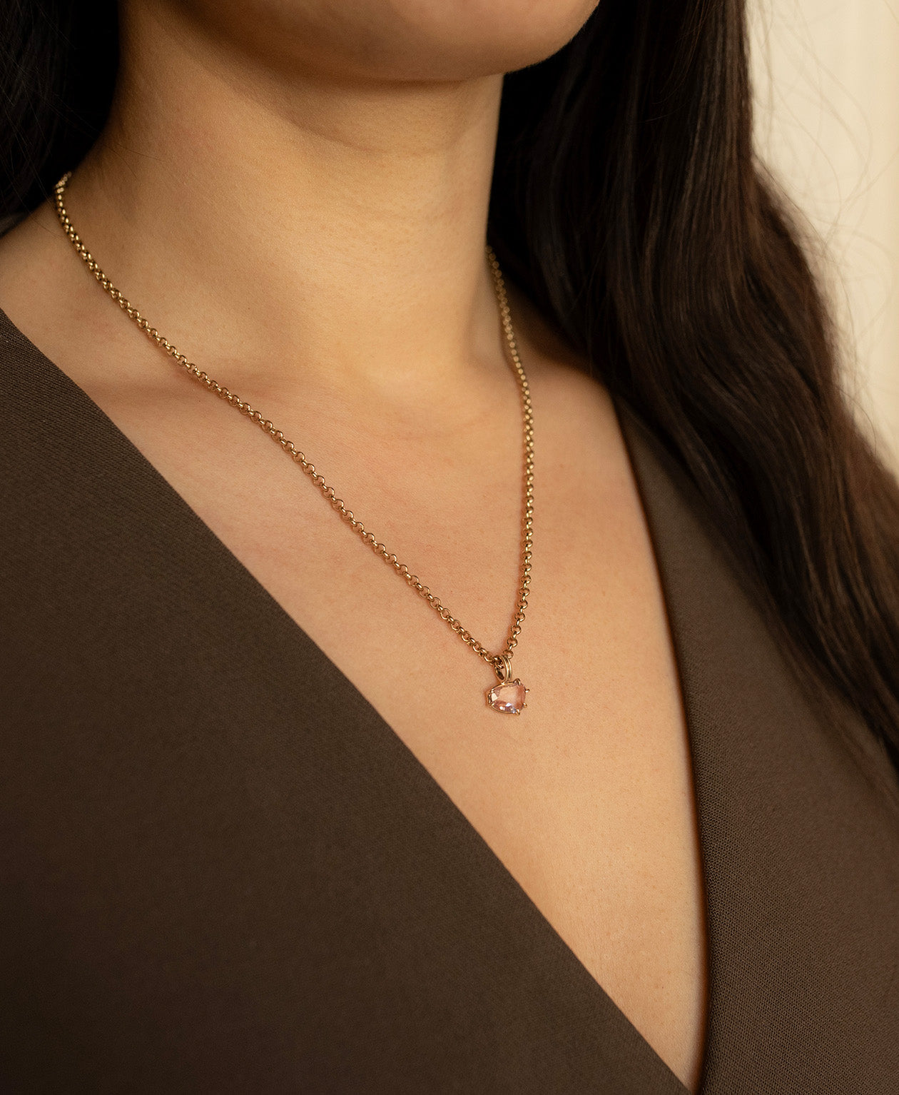 Close up of the One of a Kind Charm 496 with a pink sapphire worn by a model on a belcher chain.
