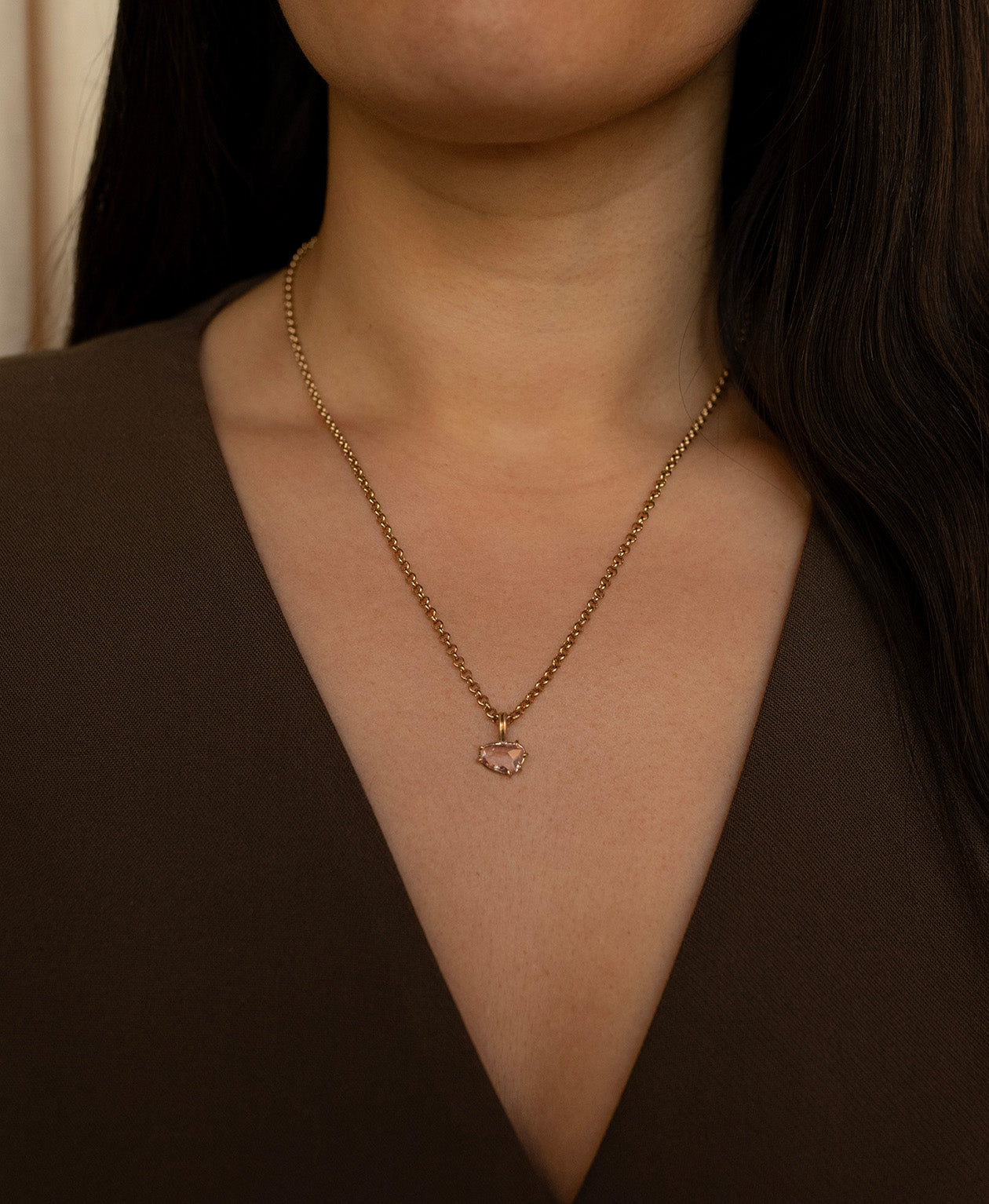 One of a Kind Charm 496 with a pink sapphire worn by a model on a belcher chain.
