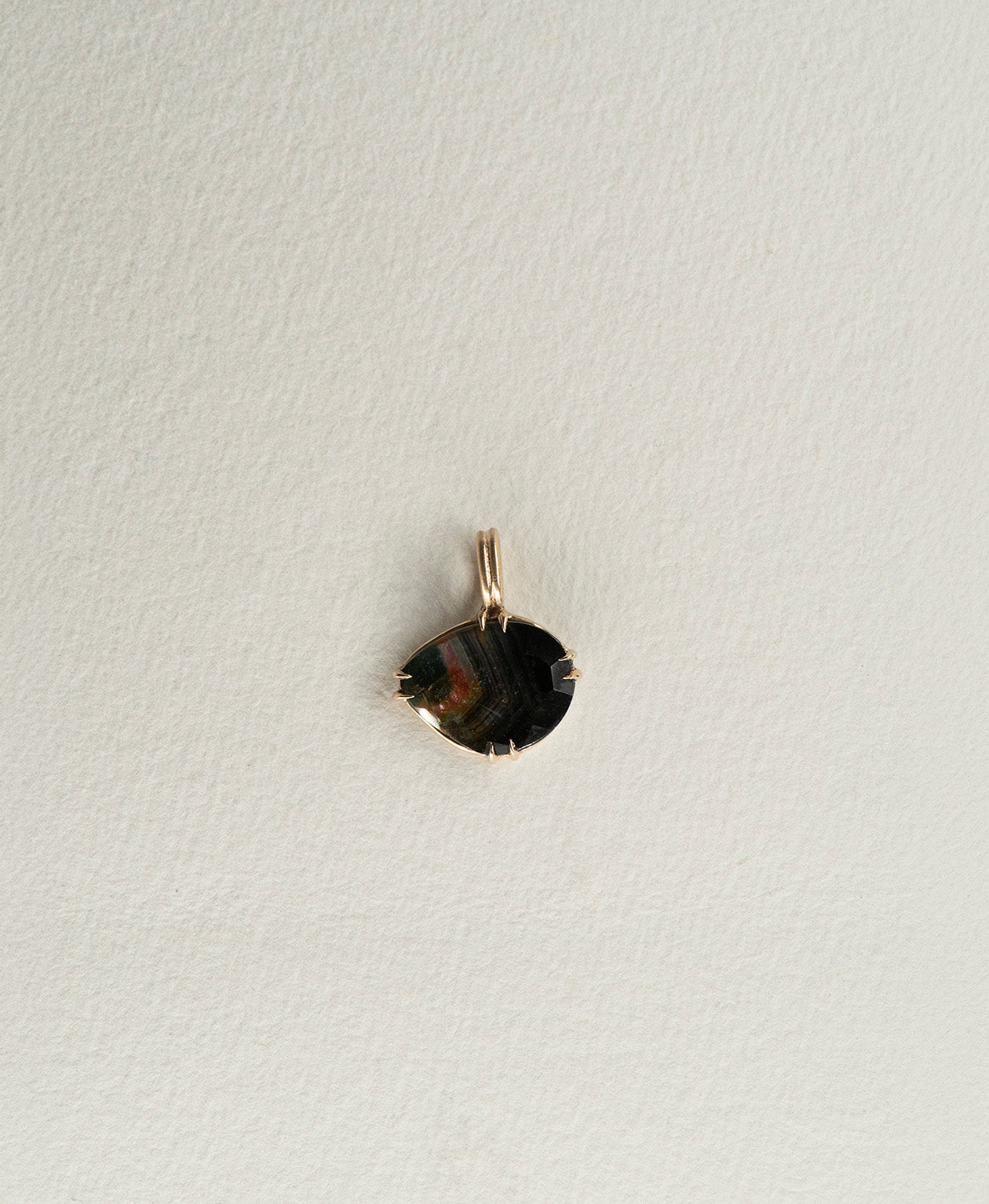 One of a Kind Charm 498 in 9k Yellow Gold featuring a rose cut black Tourmaline with a claw setting.