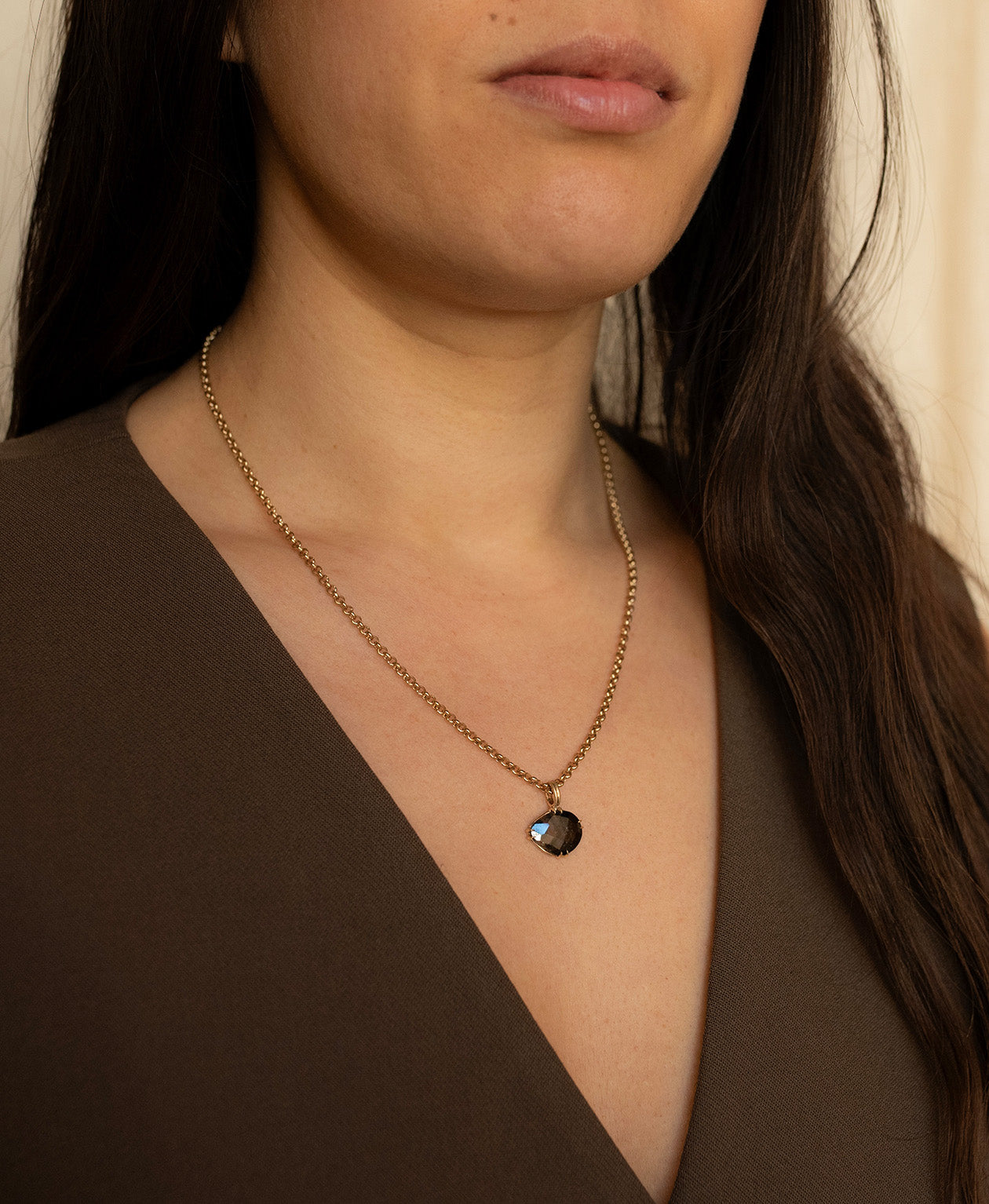 Close up of the One of a Kind Charm 498 with a rose cut black Tourmaline worn by a model on a belcher chain.