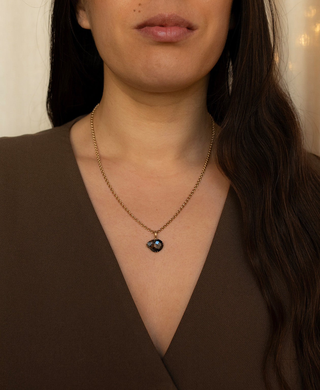 One of a Kind Charm 498 with a rose cut black Tourmaline worn by a model on a belcher chain.
