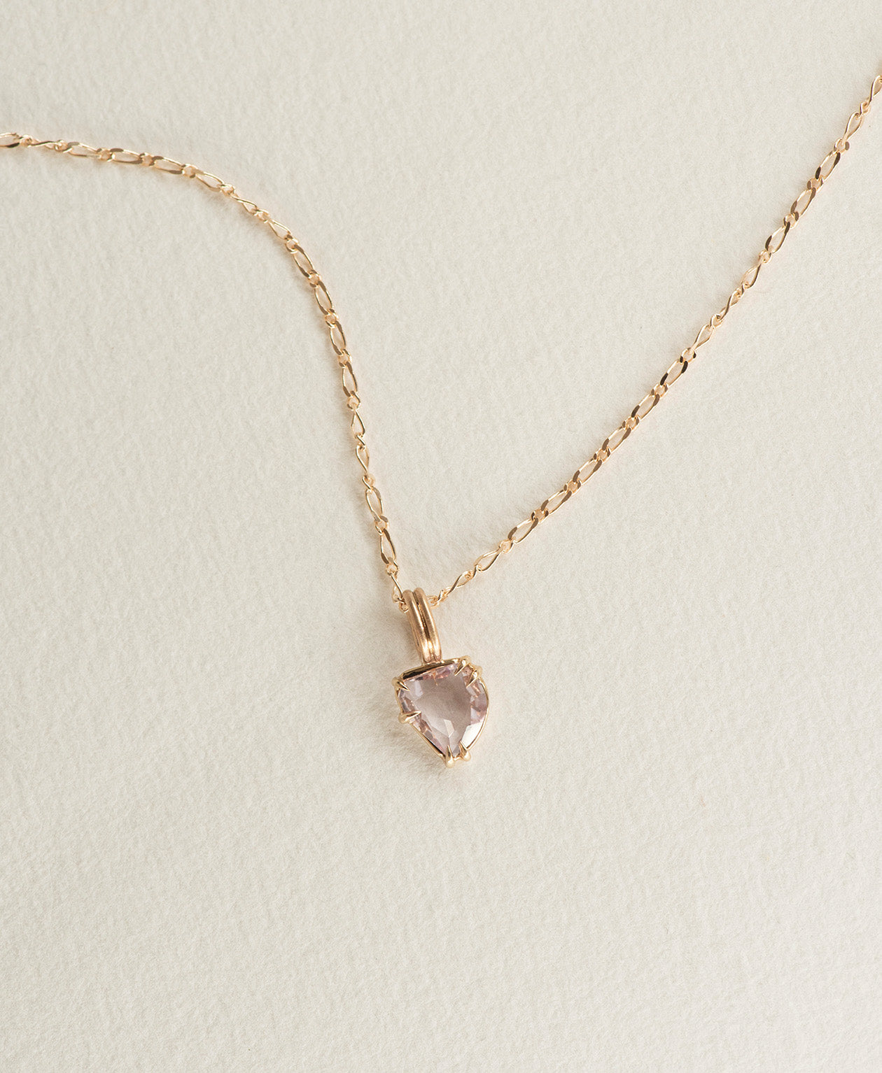 One of a Kind Charm 499 with a light pink rose cut Sapphire on a fine figaro chain.