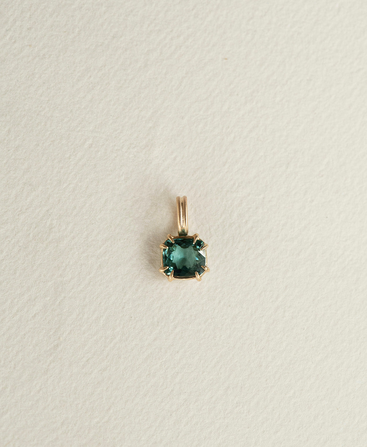 One of a Kind Charm 501 in 9k Yellow Gold featuring a vibrant teal cushion cut Tourmaline with a claw setting.