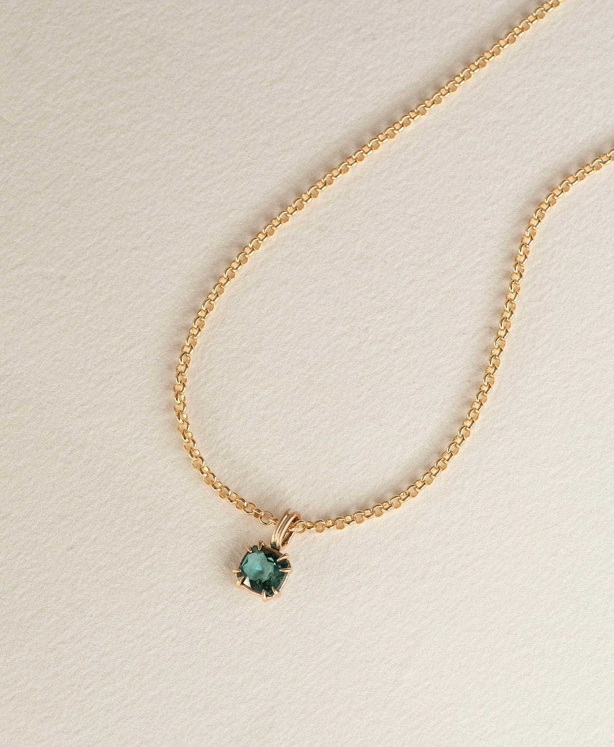 One of a Kind Charm 501 with a teal cushion cut Tourmaline on a belcher chain.