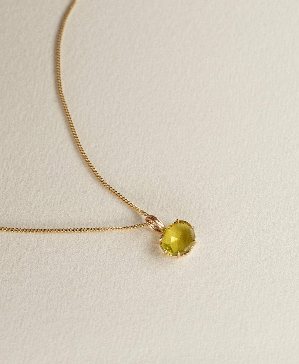 One of a Kind Charm 503 with a rose cut green Tourmaline on a curb chain.