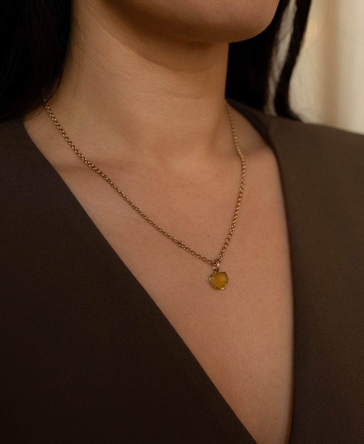 One of a Kind Charm 503 with a rose cut green Tourmaline worn by a model on a fine belcher chain.