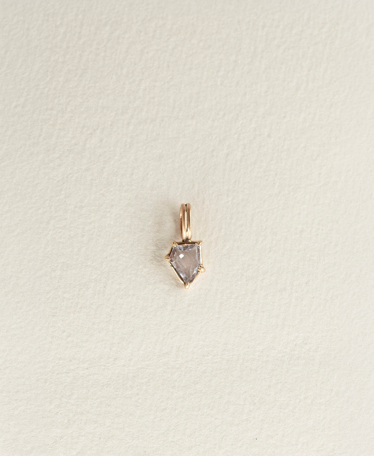 One of a Kind Charm 506 in 9k Yellow Gold featuring a light blue portrait cut Sapphire with a claw setting.