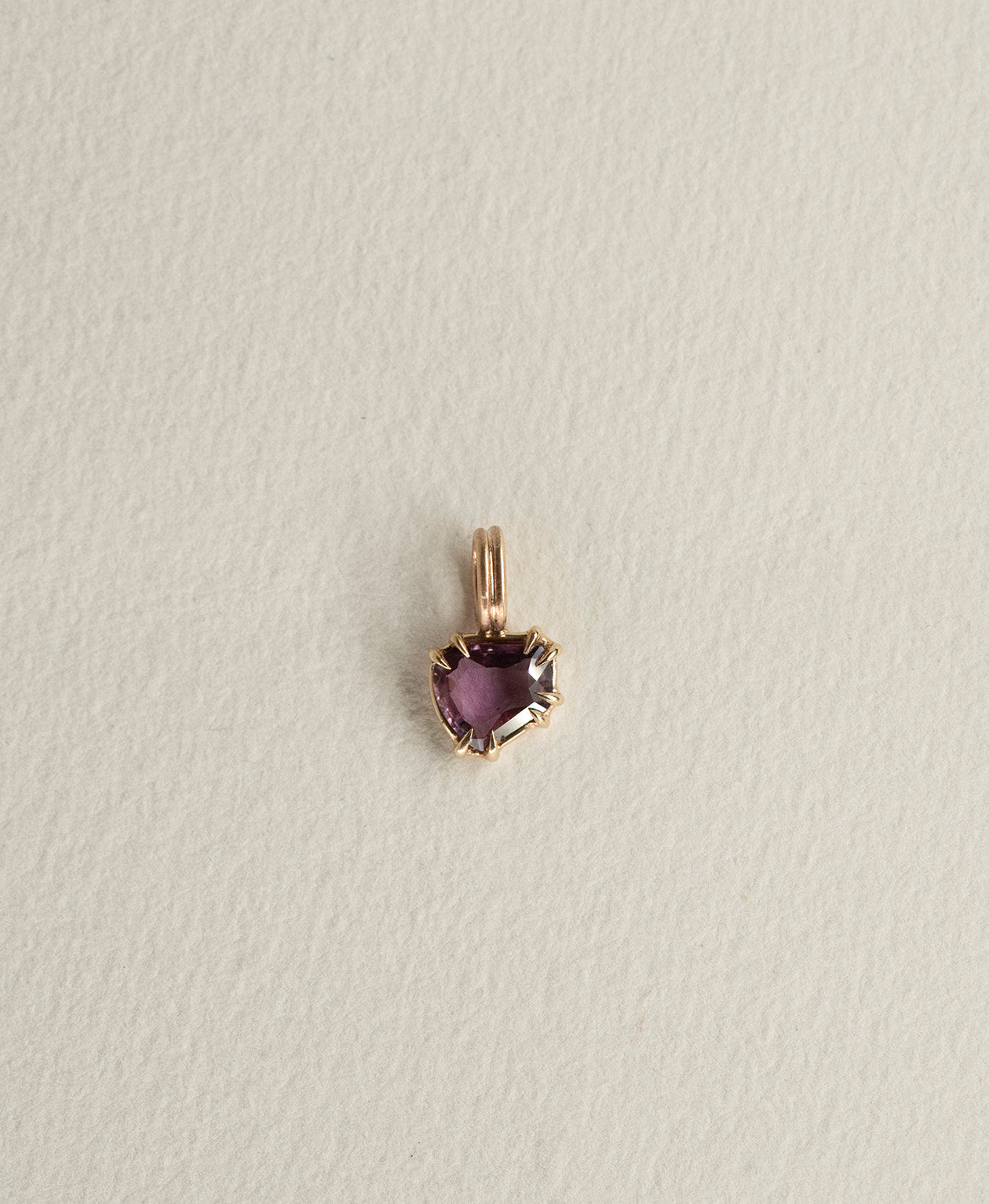 One of a Kind Charm 507 in 9k Yellow Gold featuring a deep purple portrait cut Sapphire with a claw setting.