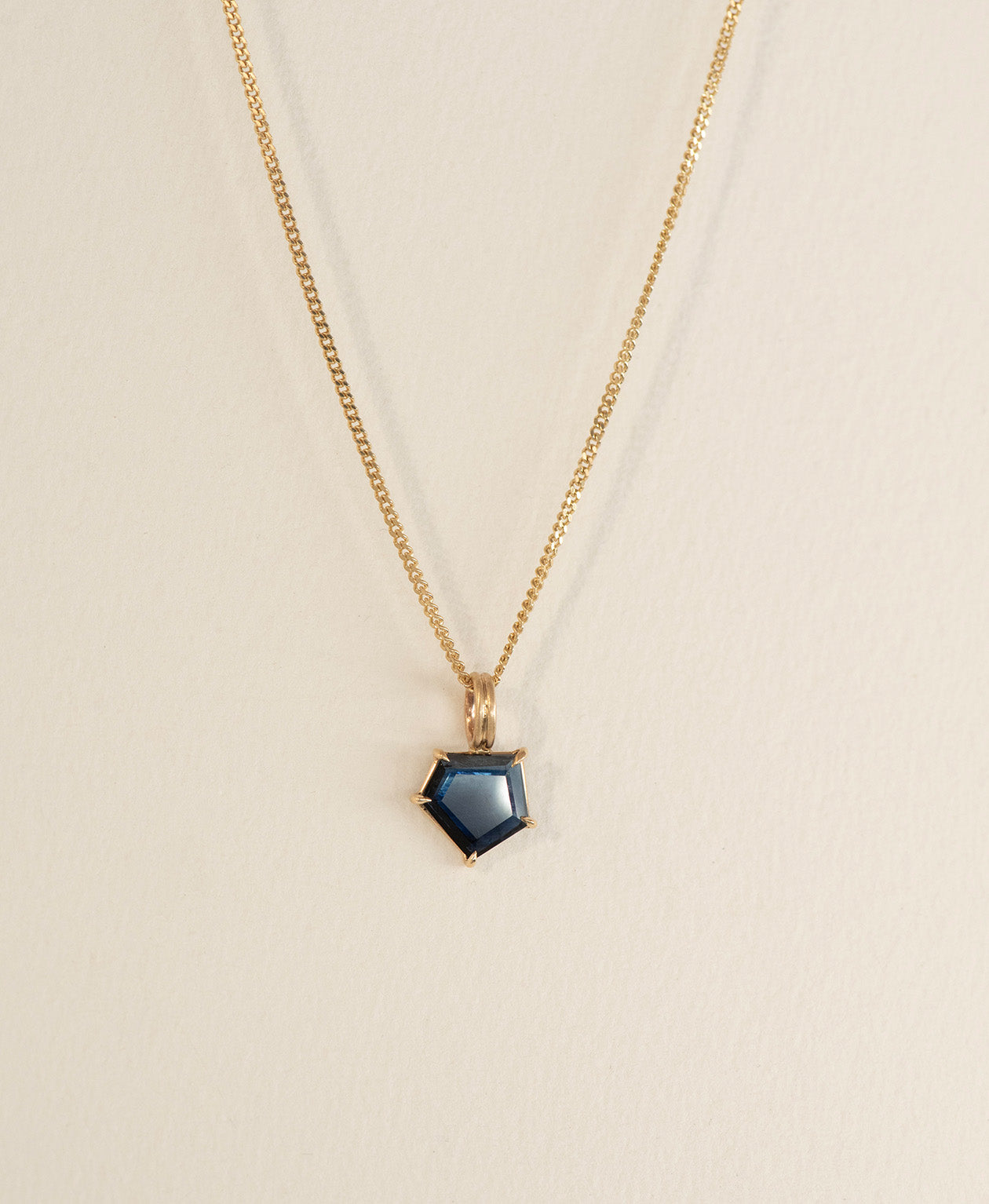 One of a Kind Charm 508 with a deep blue portrait cut Sapphire on a curb chain.