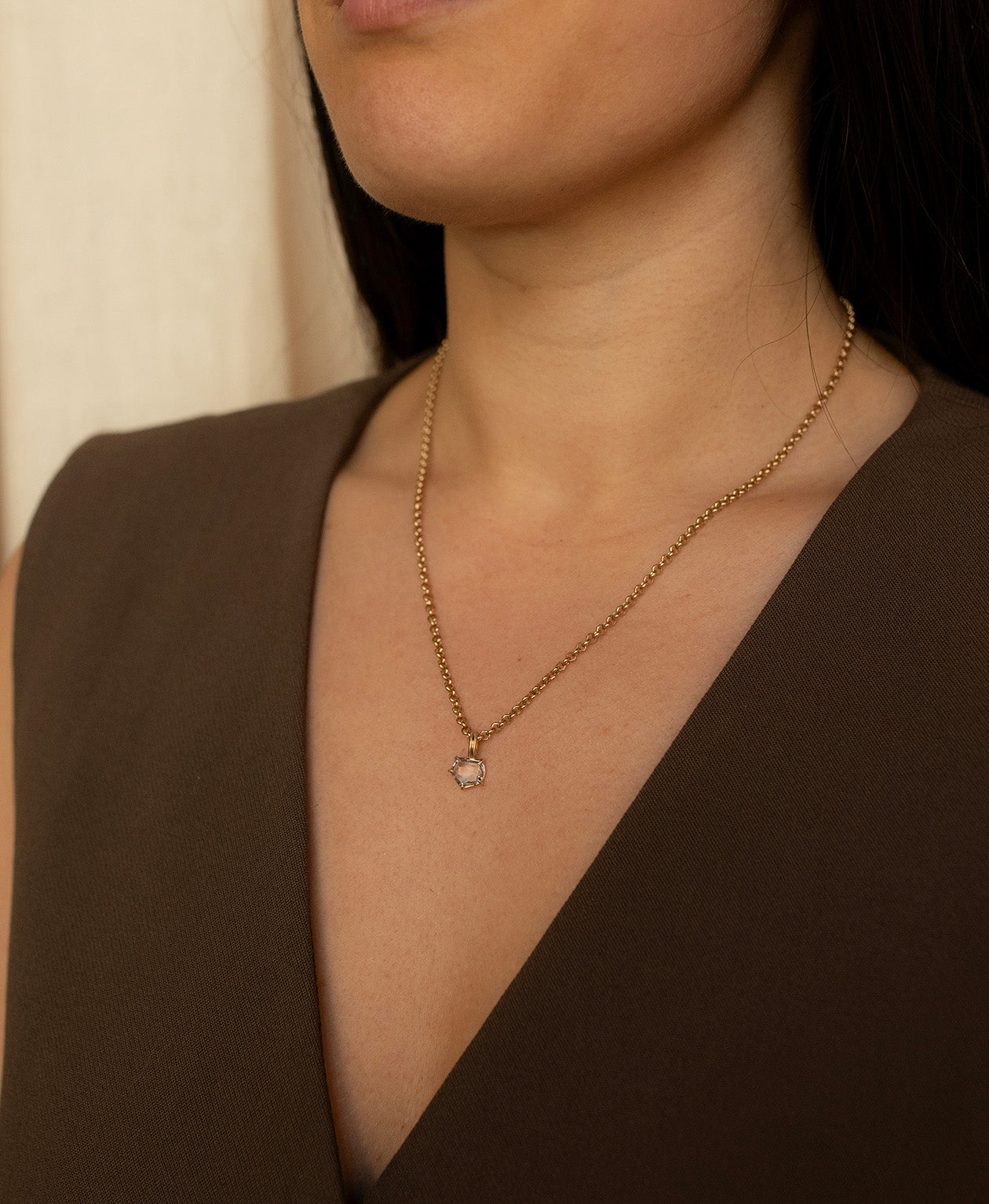 One of a Kind Charm 511 with a lilac portrait cut Sapphire worn by a model on a fine belcher chain.