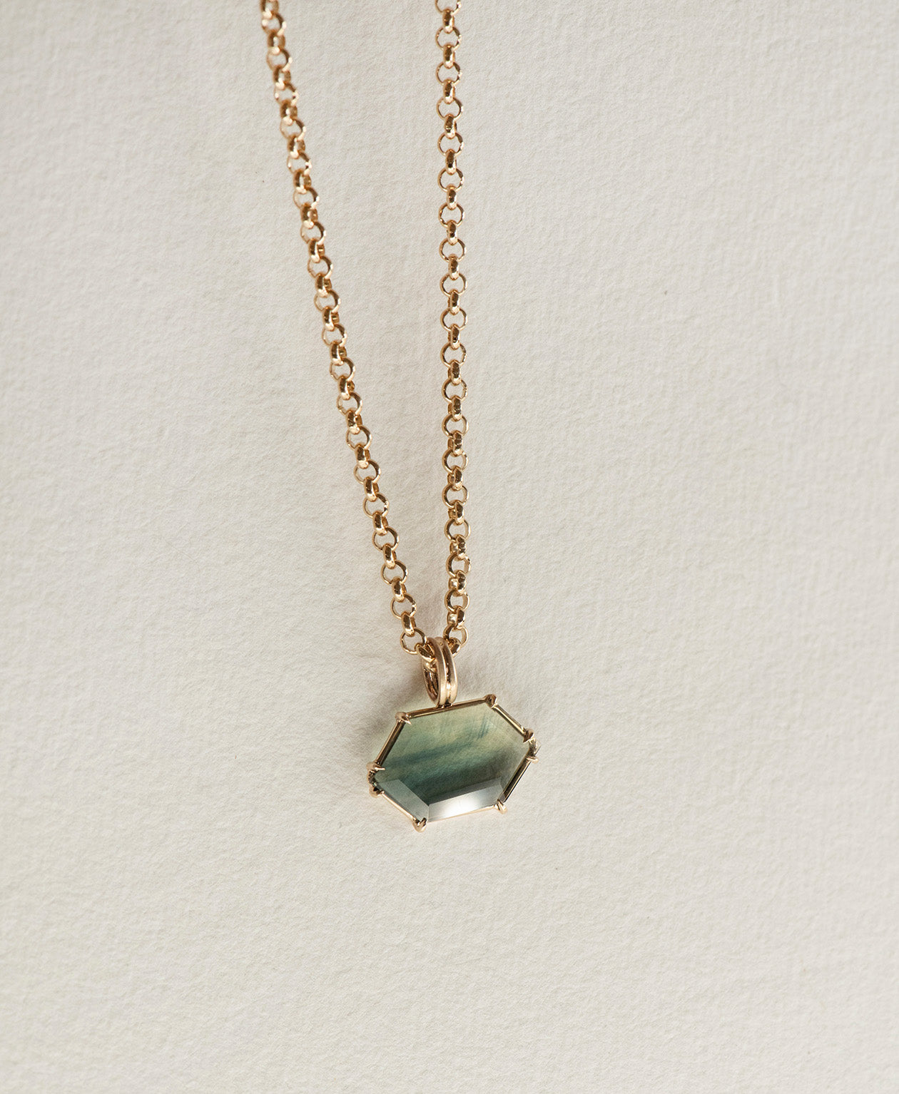One of a Kind Charm 512 with a light teal portrait cut Australian Sapphire on a belcher chain.