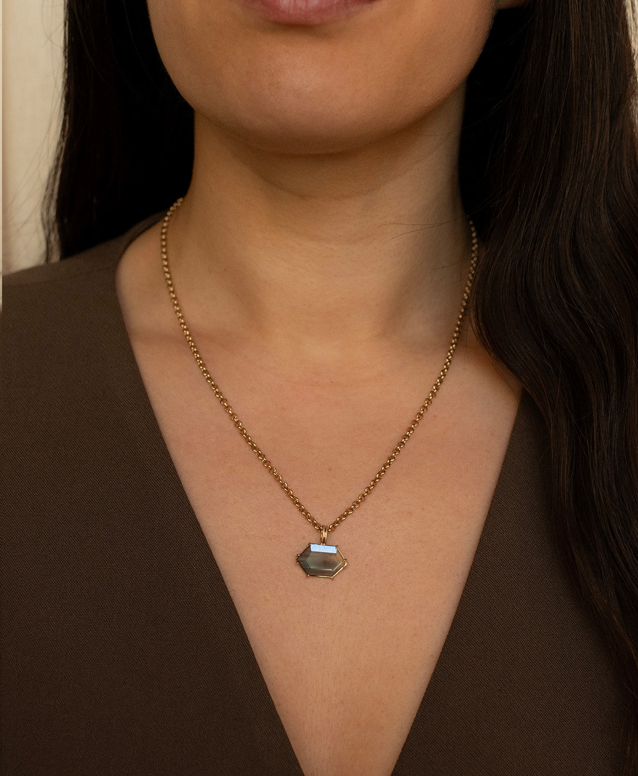 One of a Kind Charm 512 with a light teal portrait cut Australian Sapphire worn by a model on a belcher chain.