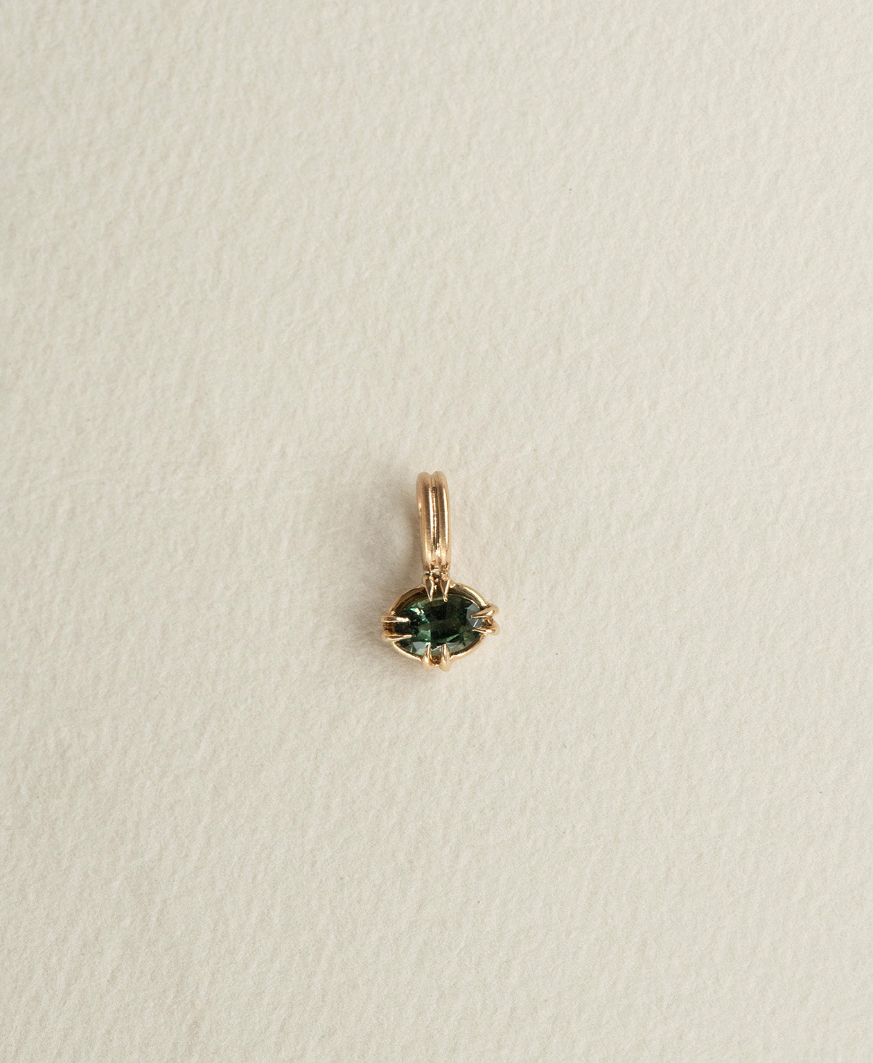 One of a Kind Charm 515 in 9k Yellow Gold featuring a forest green oval cut Sapphire with a claw setting.