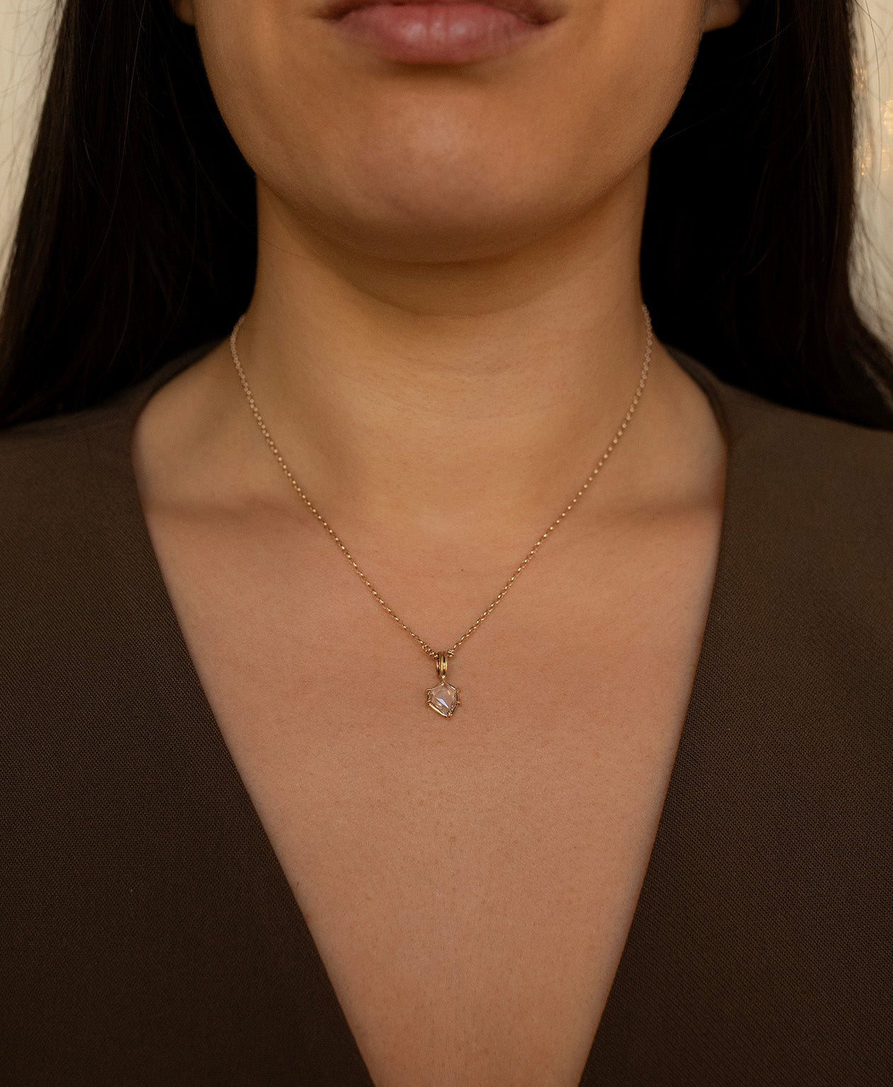 One of a Kind Charm 516 with a white portrait cut Sapphire worn by a model on a fine belcher chain.