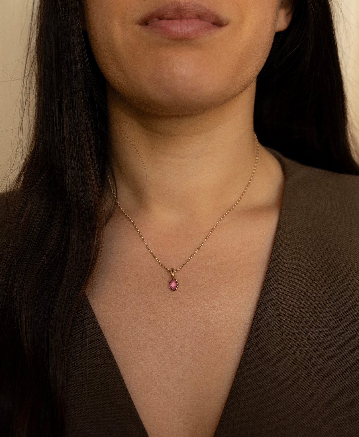 One of a Kind Charm 517 with a pale purple portrait cut Sapphire worn by a model on a fine belcher chain.