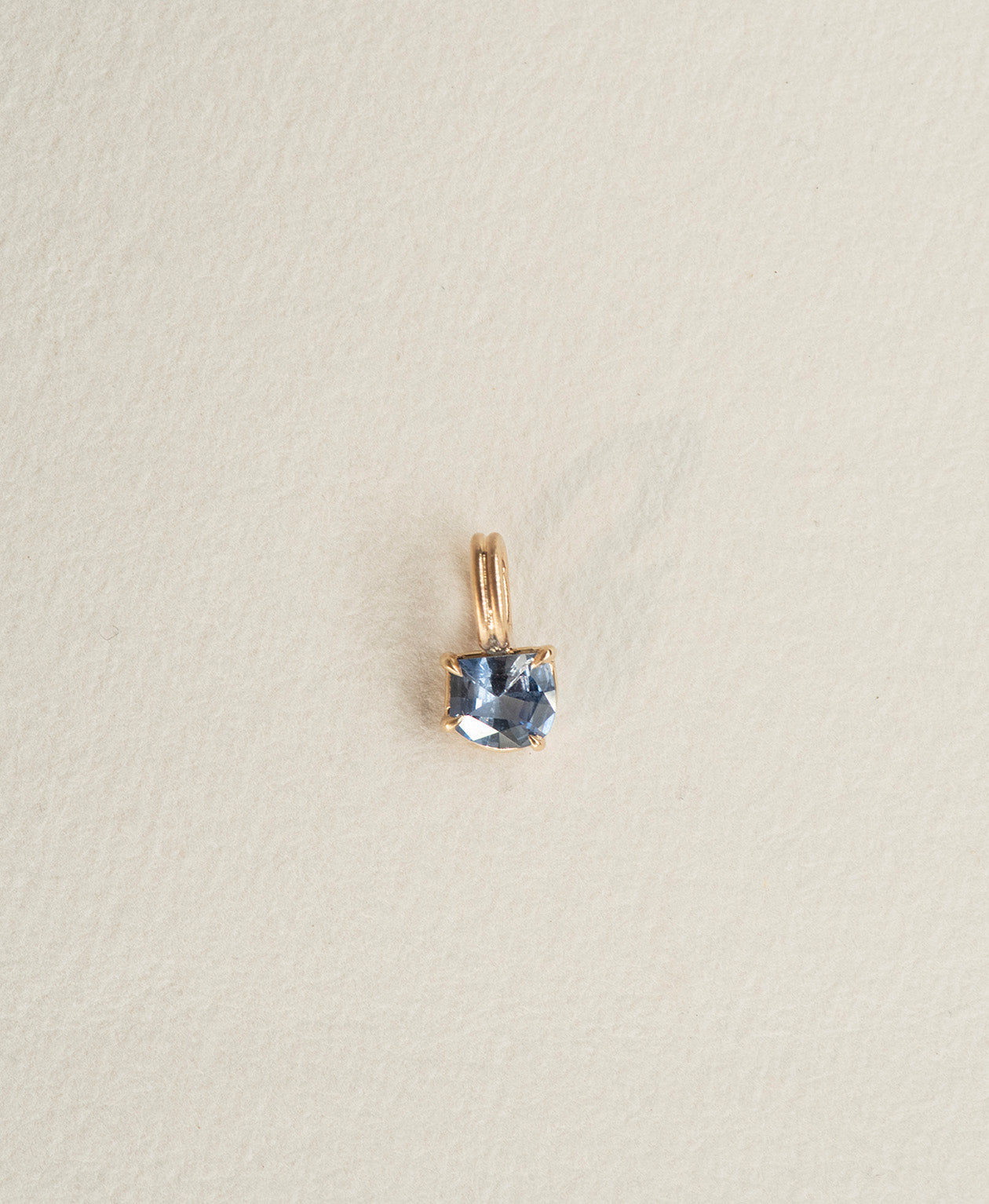One of a Kind Charm 518 in 9k Yellow Gold featuring a blue fancy cut Sapphire with a claw setting.