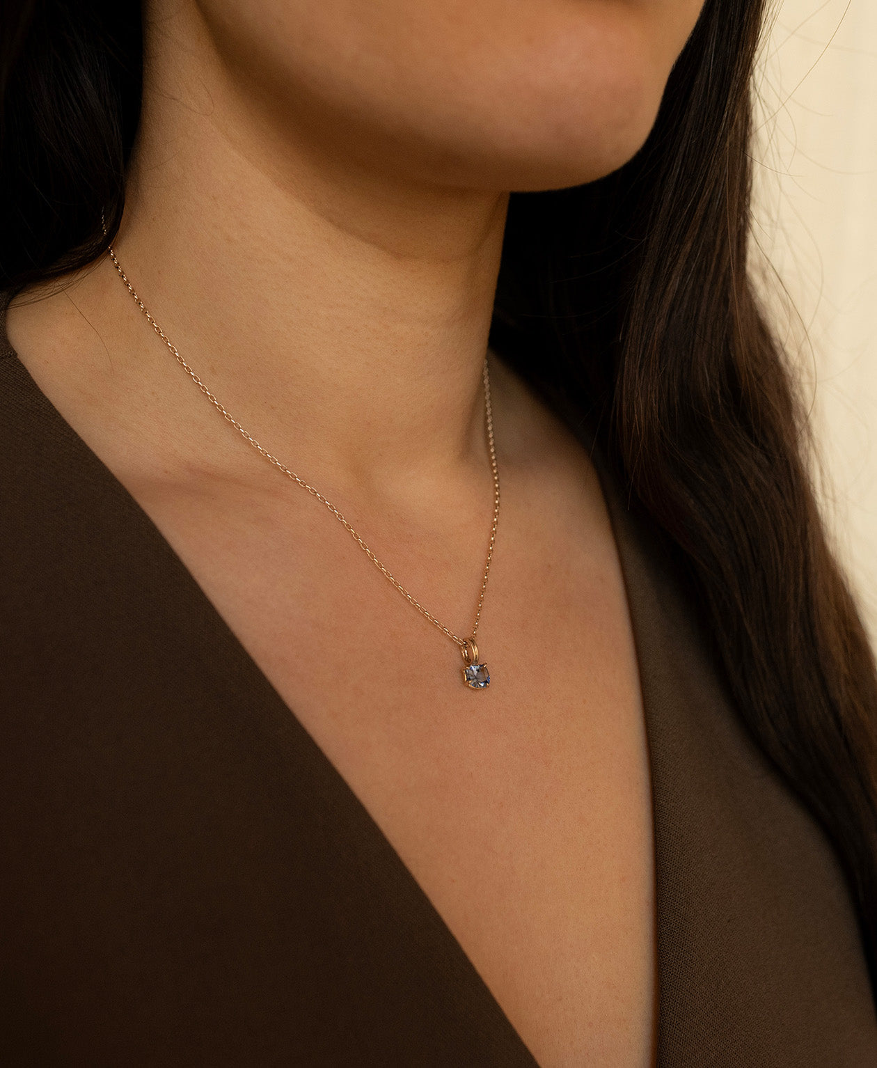 One of a Kind Charm 518 with a blue fancy cut Sapphire worn by a model on a fine belcher chain.