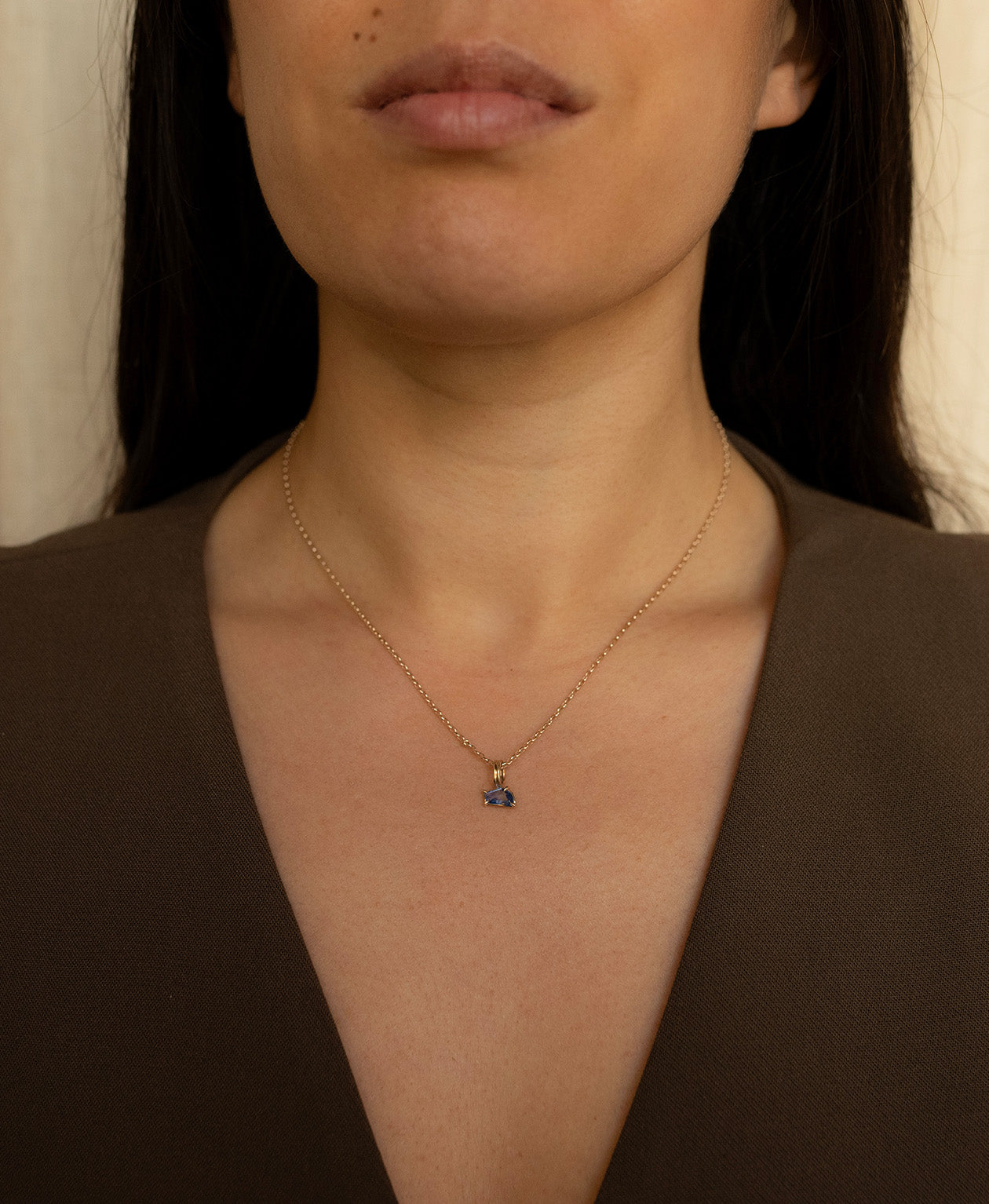 One of a Kind Charm 519 with a blue fancy cut Sapphire worn by a model on a fine belcher chain.
