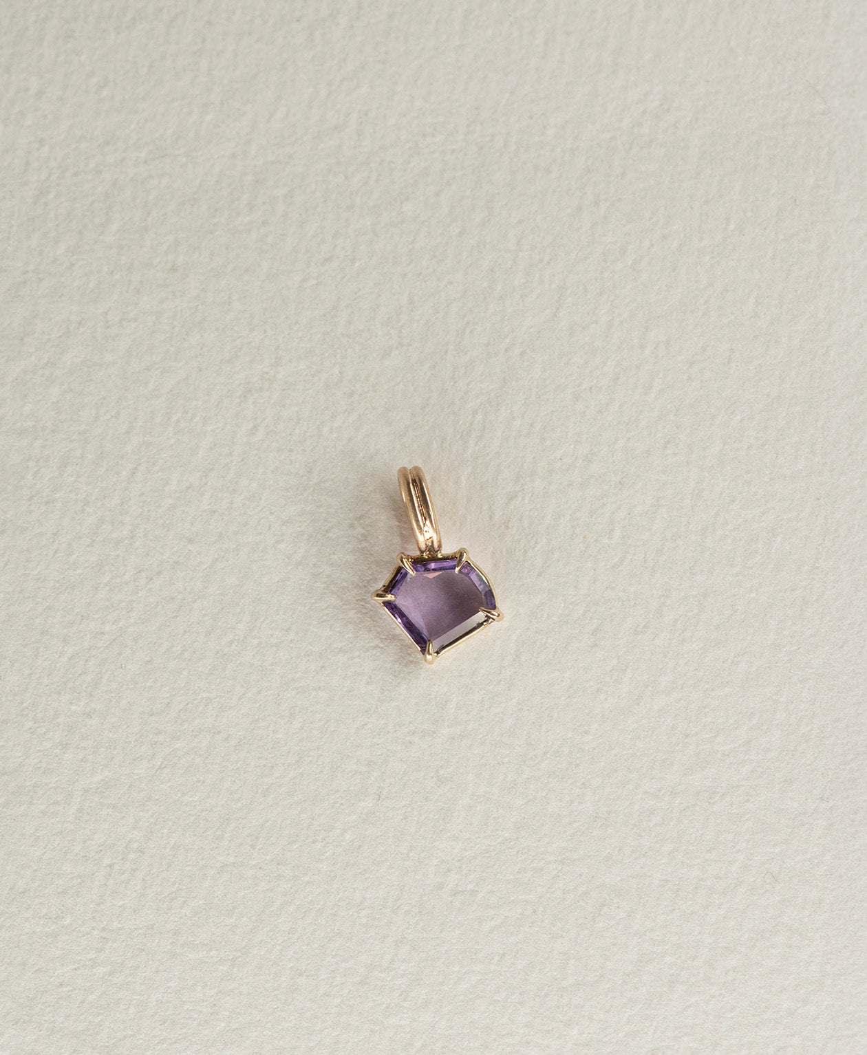 One of a Kind Charm 495 in 9k Yellow Gold featuring a portrait cut purple sapphire with a claw setting.