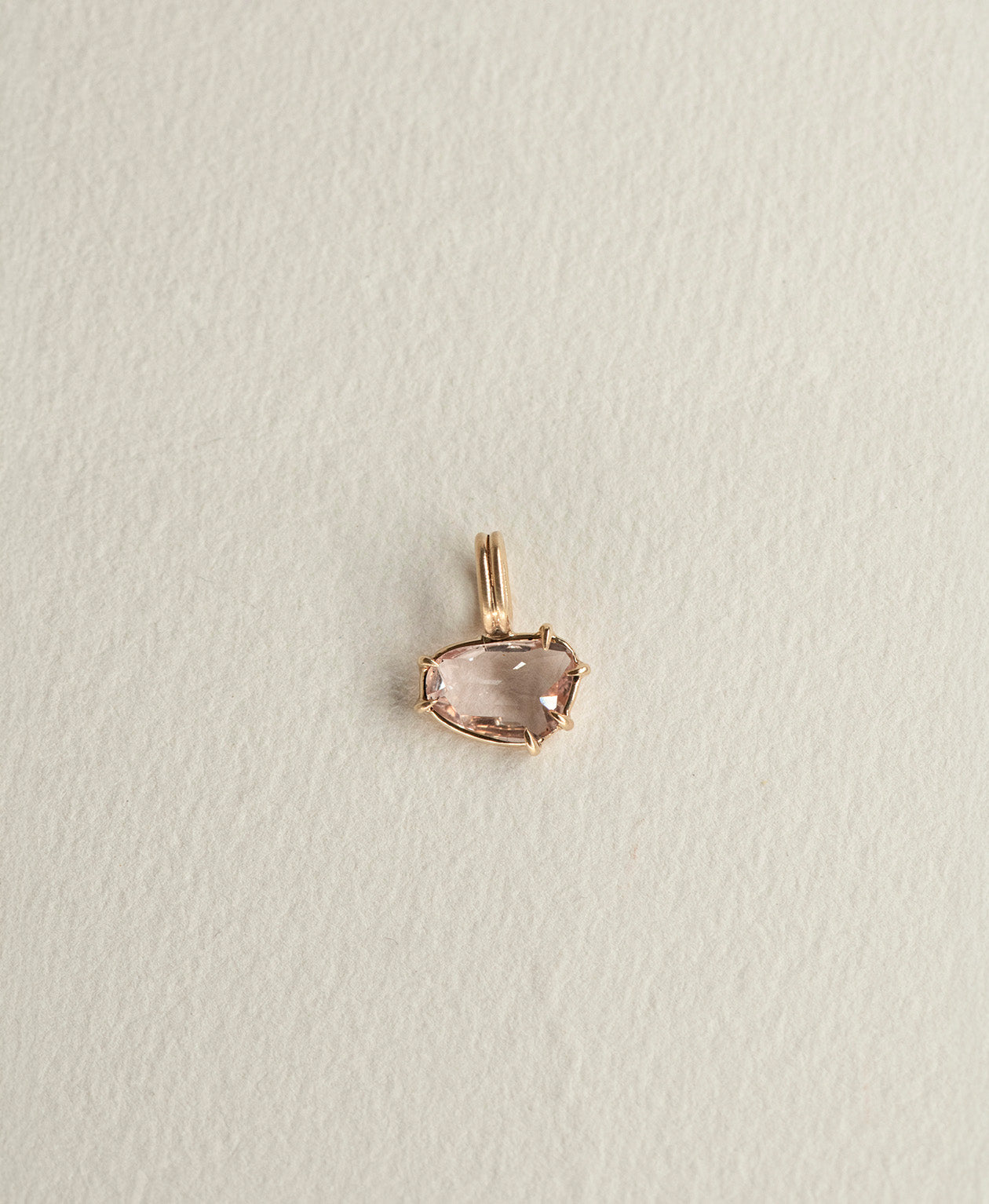 One of a Kind Charm 496 in 9k Yellow Gold featuring a pink sapphire with a claw setting.