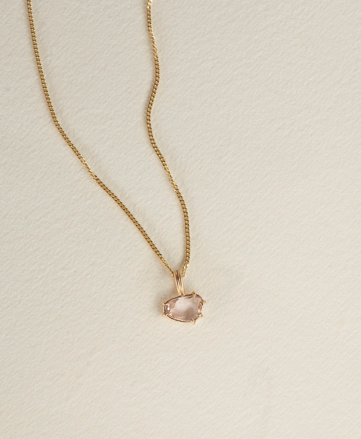 One of a Kind Charm 496 with a pink sapphire on a curb chain.