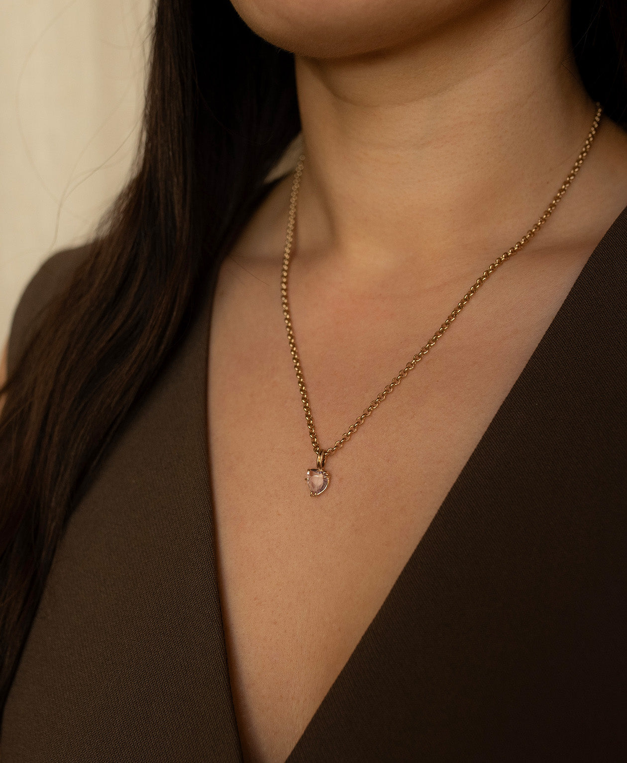 One of a Kind Charm 499 with a light pink rose cut Sapphire worn by a model on a belcher chain. 