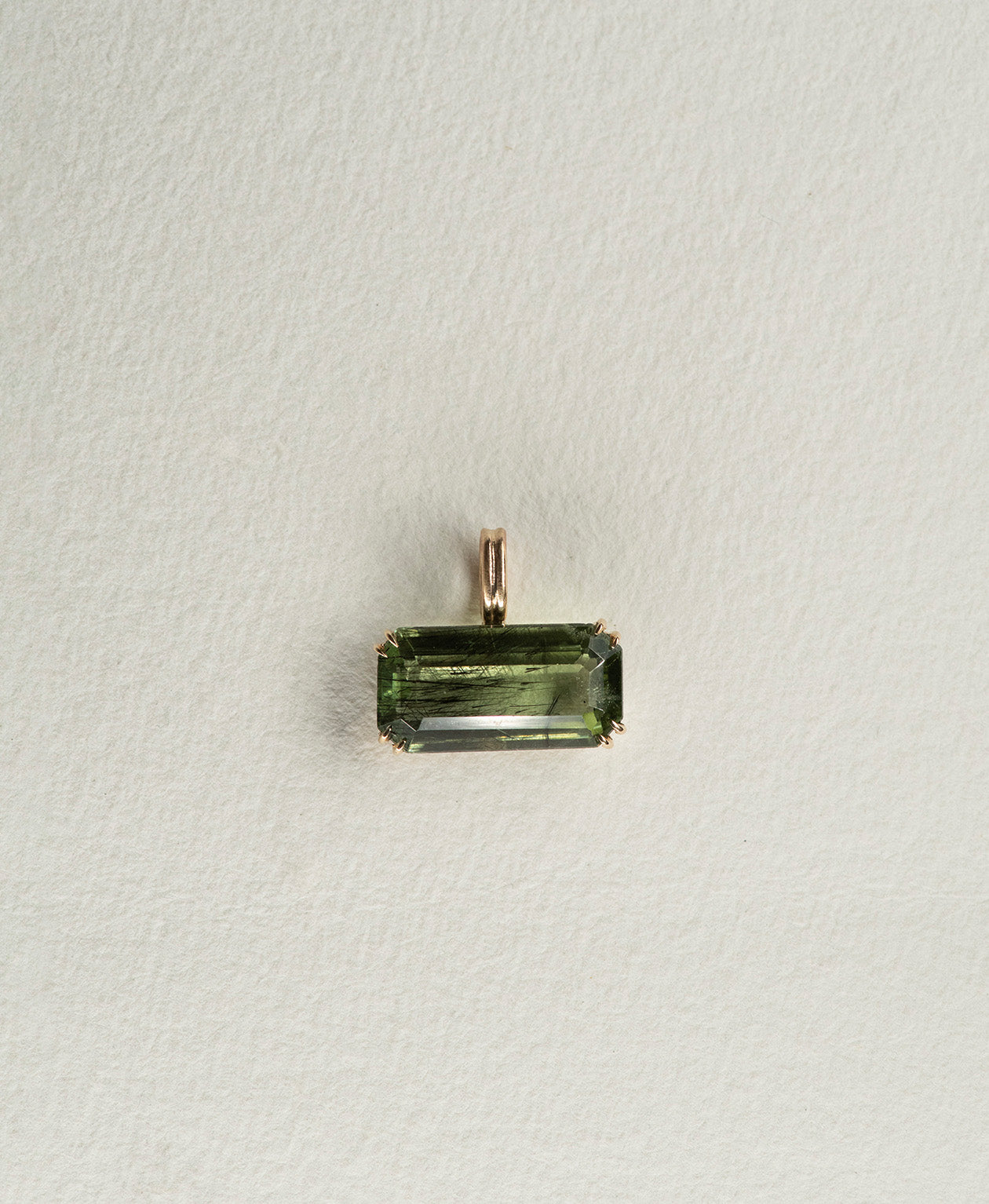 One of a Kind Charm 502 in 9k Yellow Gold featuring a deep green emerald cut Peridot with a claw setting.