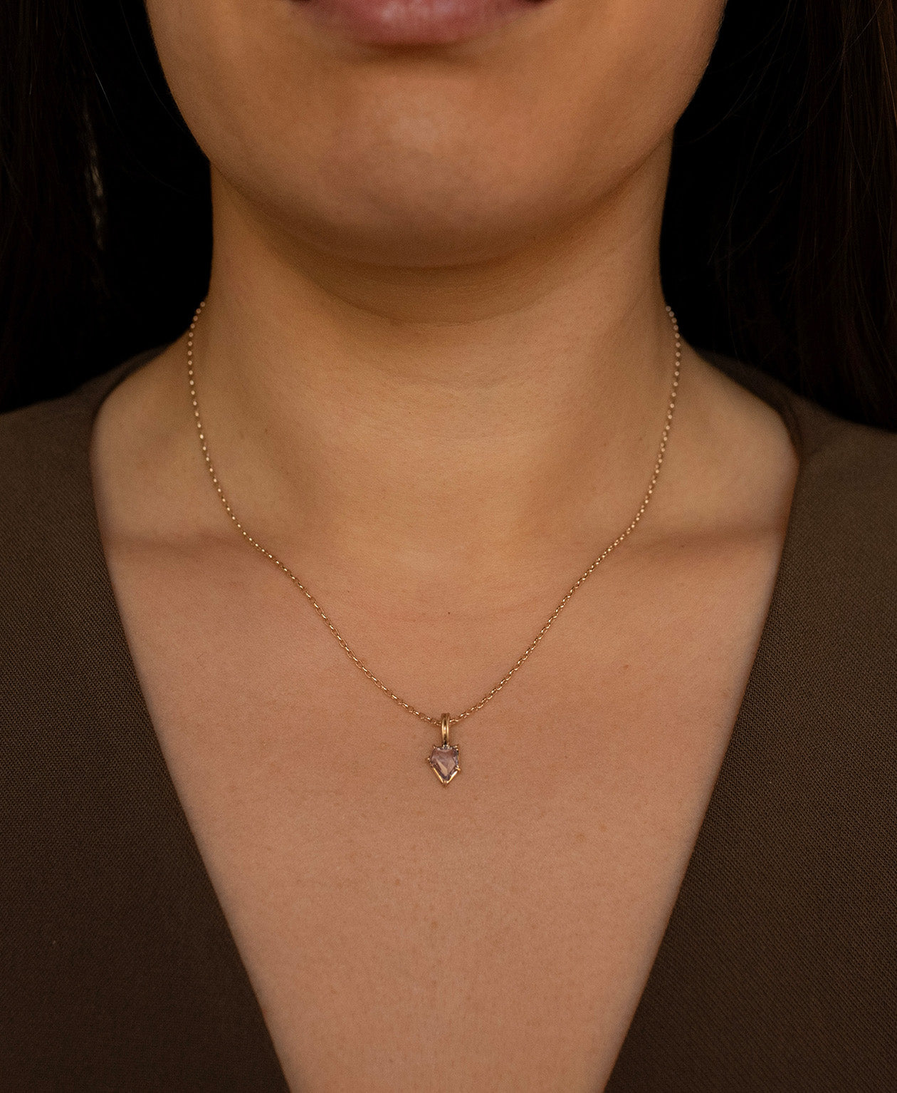 One of a Kind Charm 506 with a light blue portrait cut Sapphire worn by a model on a fine belcher chain.