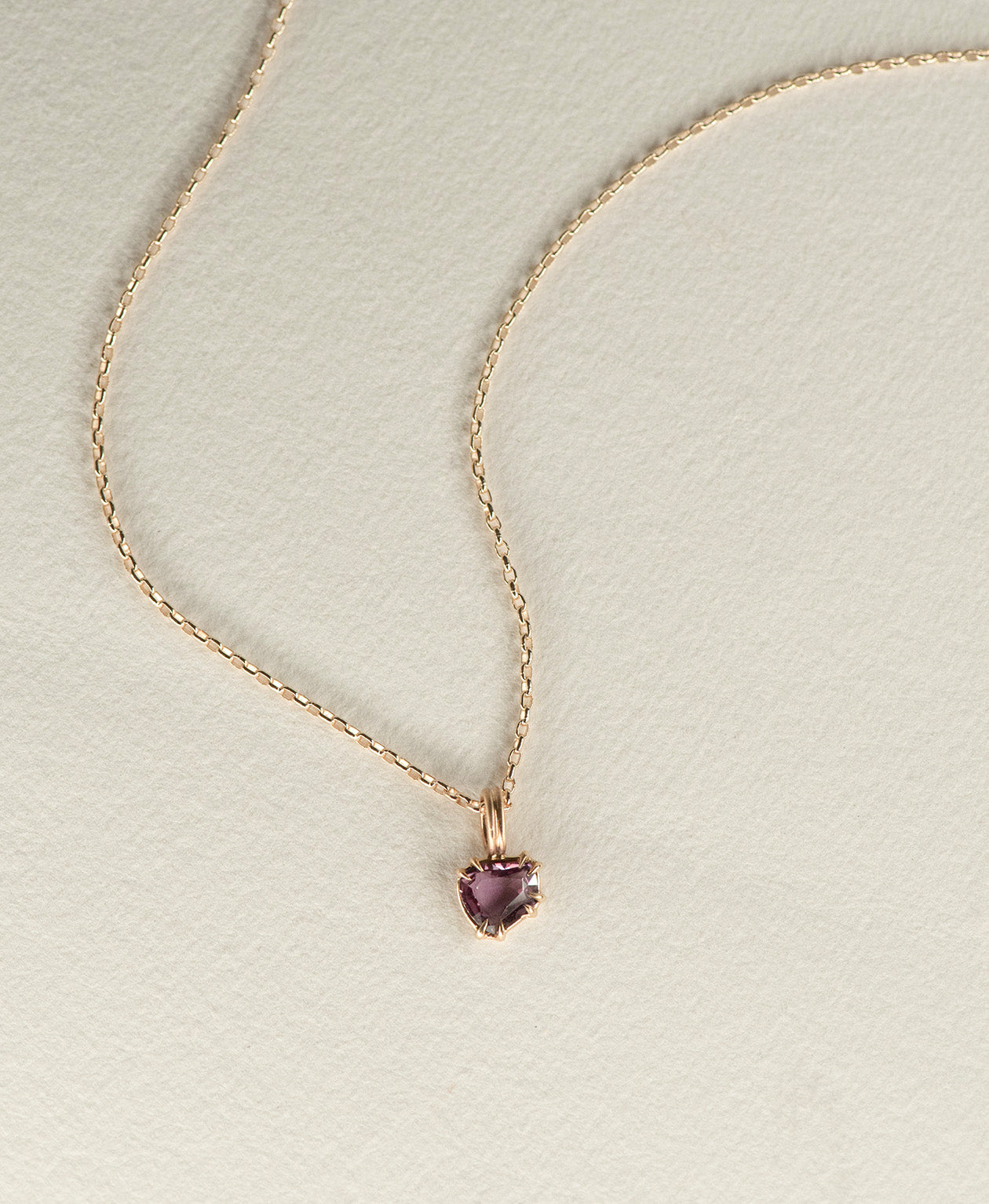 One of a Kind Charm 507 with a deep purple portrait cut Sapphire on a belcher chain.