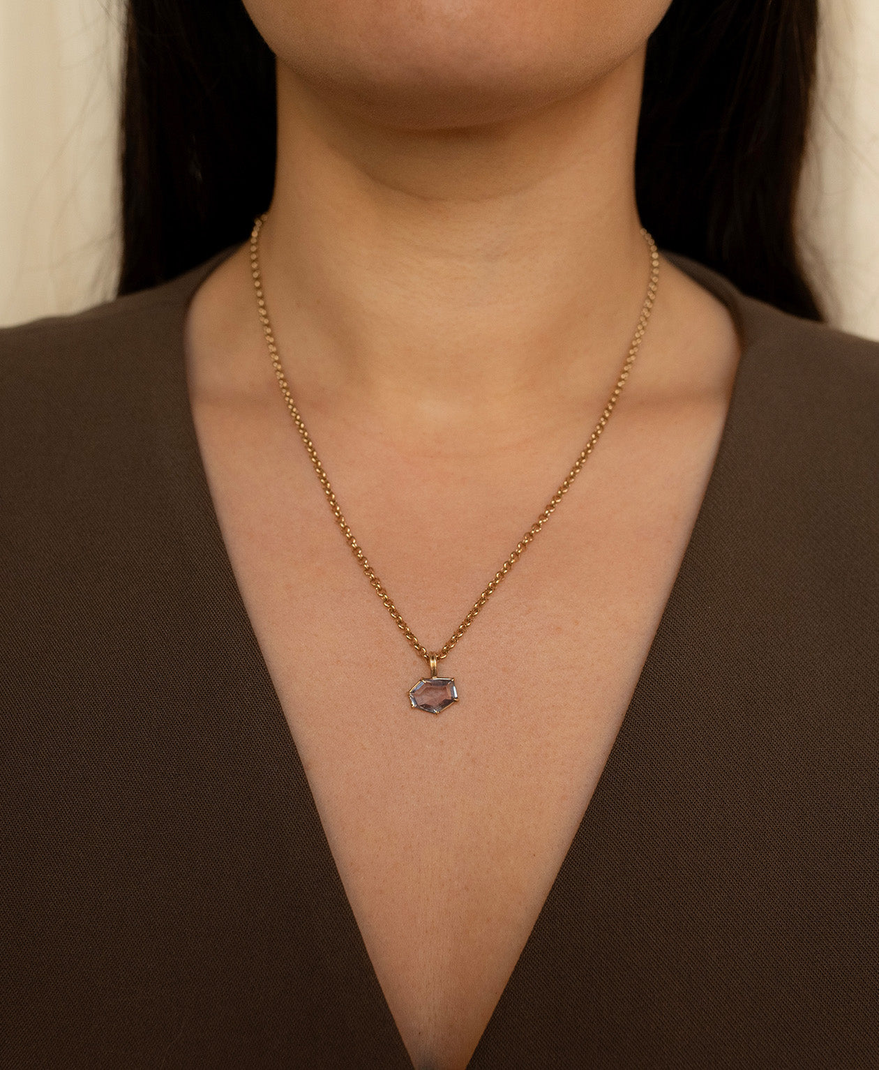 One of a Kind Charm 509 with a lilac hexagonal cut Sapphire worn by a model on a belcher chain. 