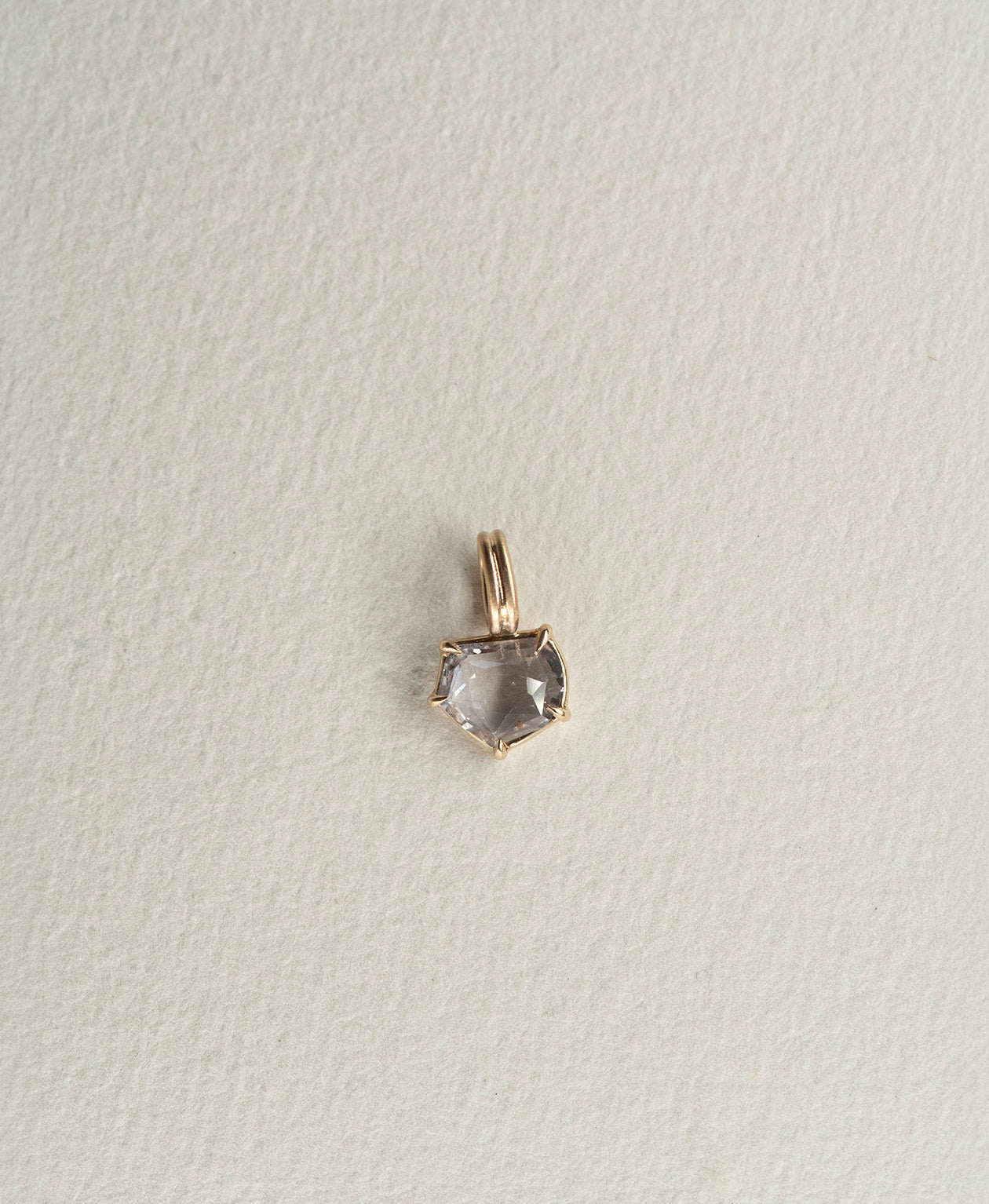 One of a Kind Charm 511 in 9k Yellow Gold featuring a lilac portrait cut Sapphire with a claw setting.
