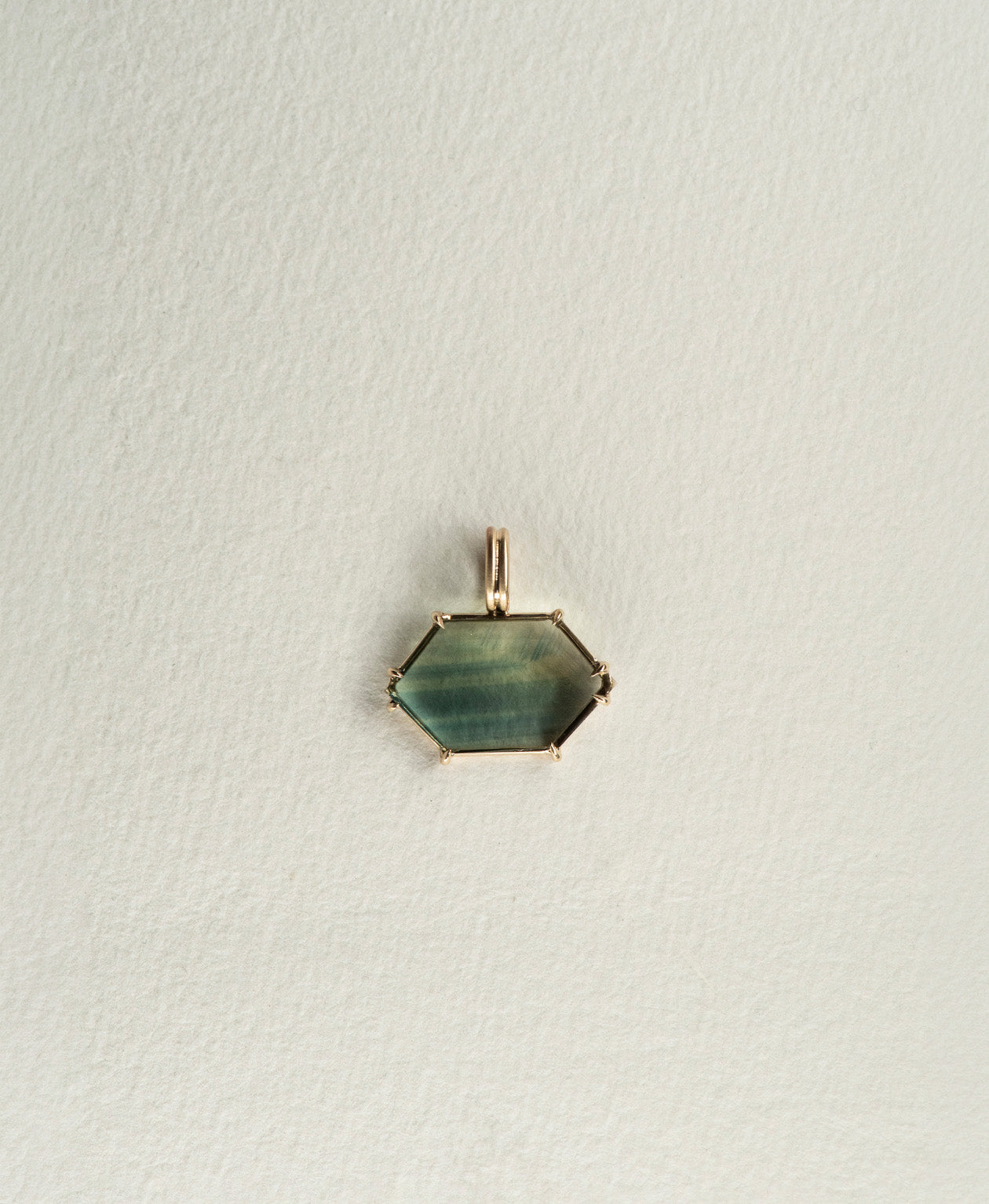 One of a Kind Charm 512 in 9k Yellow Gold featuring a light teal portrait cut Australian Sapphire with a claw setting.