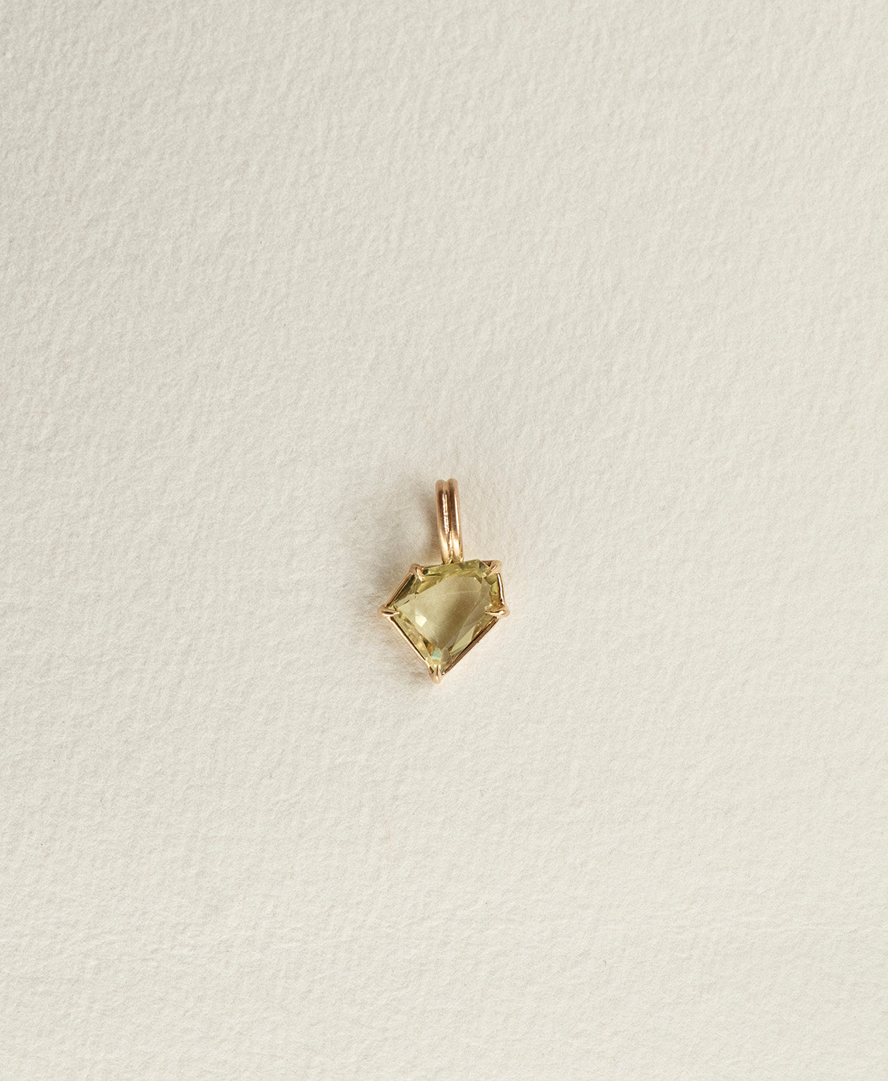One of a Kind Charm 514 in 9k Yellow Gold featuring a light yellow portrait cut Sapphire with a claw setting.