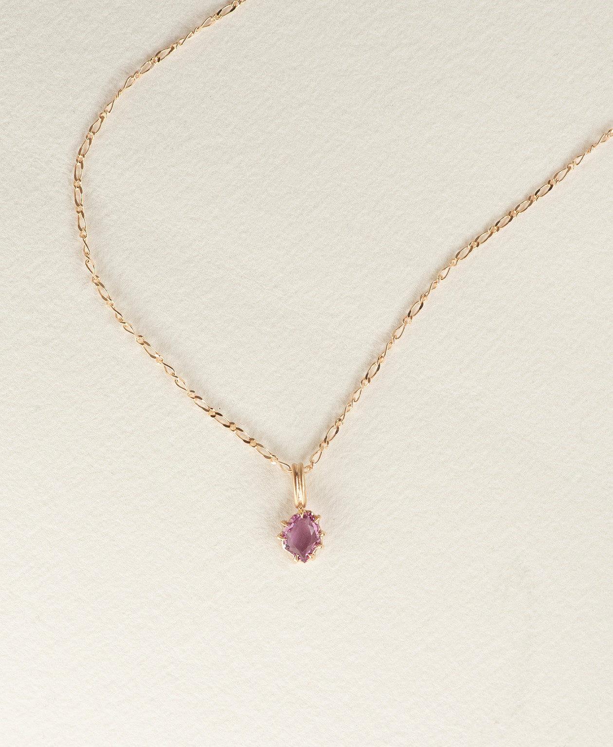One of a Kind Charm 517 with a pale purple portrait cut Sapphire worn by a model on a fine belcher chain. 